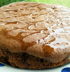 a close up of a cake on a plate with syrup drizzled over it