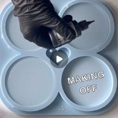 a person sitting on top of a blue plate with the words making off below it