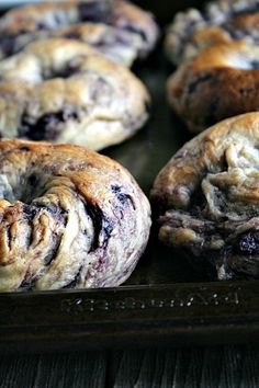 chocolate chip donuts sitting on top of a baking sheet