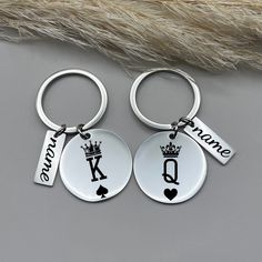 two personalized keychains with the names of two people and one has a crown on it