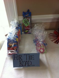 the table is set up with plastic bags and candy for the road sign on it