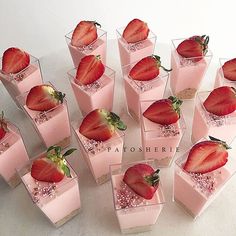 there are many small cups with strawberries in them