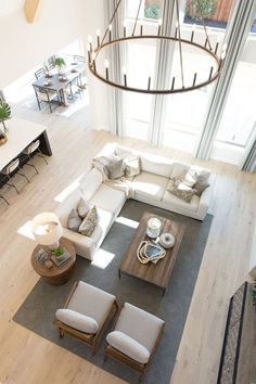 an overhead view of a living room with white furniture