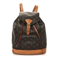 This is the authentic LOUIS VUITTON Monogram Montsouris MM Backpack. This stylish backpack is crafted of classic Louis Vuitton monogram coated canvas, with vachetta trim including adjustable shoulder straps, cinch cord, and base. The bag features an exterior zipper pocket and a crossover flap that secures with a belt buckle closure. This opens the bag to a cocoa brown fabric interior with a patch pocket and a gold toned D ring. Mochila Louis Vuitton, Louis Vuitton Backpack, Stylish Backpack, Stylish Backpacks, Cocoa Brown, Brown Fabric, Vintage Louis Vuitton, D Ring, Belt Buckle