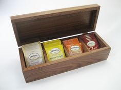 an open wooden box containing three different types of teas