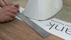 a person is using a knife to cut paper