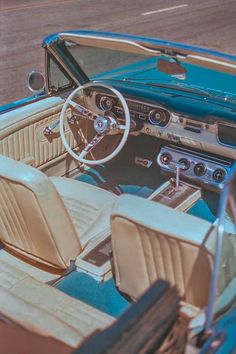 the interior of an older model car is blue and white with tan leather upholstered