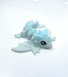 a blue toy laying on top of a white table