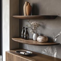 two wooden shelves with vases on them