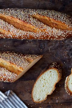 several loaves of bread sitting on top of a wooden cutting board