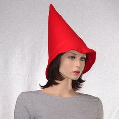 Red gnome hat with an extra wide brim. You wear this further back on your head to accommodate the extra girth of the brim. Tall and pointed made from soft fleece. Fits heads 22.5 and up. Upper portion of the hat is lined with interfacing so the hat stands tall. The bottom edge of this hat measures about 29 inches around, it is intended to be loose and flair out. Made and ready to ship, MG001464 Click here for the complete collection of holiday hats and caps. https://www.etsy.com/shop/MountainGot Red Brimmed Costume Hat One Size, Red Brimmed Hat For Costume, Red Halloween Hat One Size Fits Most, Fitted Red Halloween Hat, Red Costume Hat, Red Fitted Hat For Costume, Fitted Hat With Curved Brim For Cosplay, Fitted Curved Brim Hat For Cosplay, Fitted Brimmed Hat For Cosplay