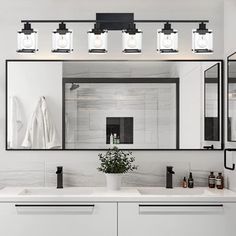 a bathroom vanity with four lights above it and a mirror on the wall next to it