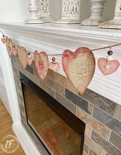 a fireplace decorated with paper hearts and string