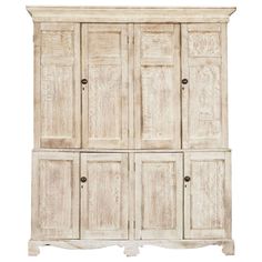 an old white wooden cabinet with four doors