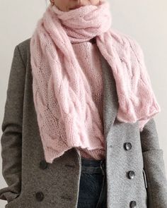 a woman wearing a pink scarf and coat