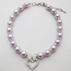 a bracelet with pearls and a heart charm