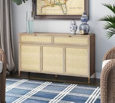 a living room with wicker furniture and a large map on the wall above it