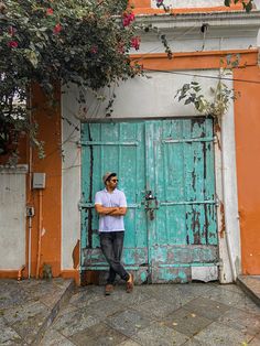 a man standing in front of a blue door