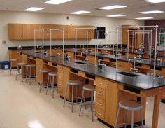 an empty lab with many tables and stools