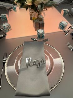 a fancy place setting with silverware and flowers