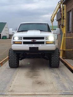 a white truck parked in front of a building