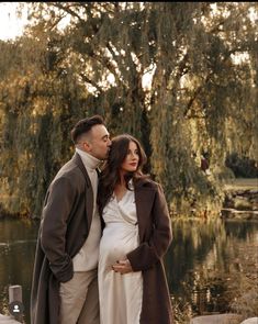 a pregnant couple standing next to each other