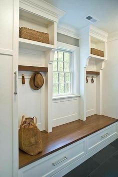 a bench with some baskets on top of it and two windows in the back ground