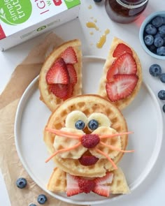 a plate topped with waffles covered in fruit