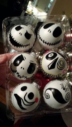 a box filled with lots of white and black decorated eggs in the shape of jack skelling