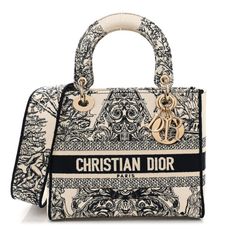 This is an authentic CHRISTIAN DIOR Toile de Jouy Embroidered Medium Lady D-Lite. This stylish handbag tote is finely crafted of embroidered Black Cannage canvas with a unique print and the 'Christian Dior' signature on the front. The bag features fabric top handles, an optional shoulder strap with gold hardware, including gold Dior letters charm. The top opens to a Dior monogram fabric interior with a hanging zipper pocket. Stile Blair Waldorf, Navy Blue Handbags, Christian Dior Bag, Luxury Bags Collection, Embroidered Canvas, Blue Handbags, Dream Bags, Fancy Bags, Pretty Bags