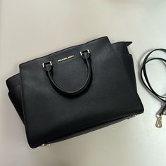 Pre Loved Condition. See Signs Of Wear Throughout In Photos. Lots Of Life Still Left In This Great Bag. Saffiano Leather. Gold Hardware. Removable Crossbody Strap. North South, Michael Kors Black, Crossbody Strap, Michael Kors Bag, Gold Hardware, Michael Kors, Bag Lady, Signs, Leather