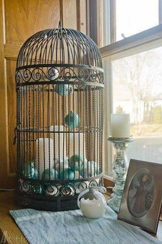 a birdcage filled with white and blue decorations