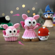 three crocheted animals sitting next to each other on top of a wooden table