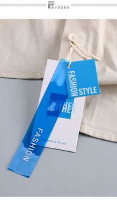 a blue and white tag with the words fashion style on it hanging from a string