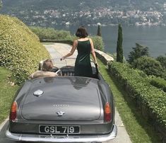 a woman standing in the back of a car