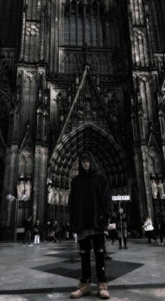 a man standing in front of a large cathedral