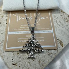 Elevate Your Style with ReluumJewellery's Country Map Pendant Necklaces: Introducing our Lebanese Cedar Tree Pendant Necklace - a proud symbol of resilience and heritage. Crafted with intricate detail, this necklace features the iconic Lebanese Cedar Tree, representing strength and endurance in Lebanese culture. Whether you're honoring your roots or drawn to its symbolism, this pendant is a perfect statement piece. 🌍 Embrace the world in style with ReluumJewellery's Country Map Pendant Necklace Silver Clavicle Necklace For Christmas, Silver Clavicle Chain Necklace For Christmas, Stainless Steel Charm Necklace With Silver Chain For Gift, Gift Stainless Steel Charm Necklace With Silver Chain, Metal Pendant Necklaces For Birthday, Metal Pendant Necklace For Birthday, Gift Stainless Steel Necklace With Lobster Clasp, Valentine's Day Silver Jewelry For Holiday, Valentine's Day Gift Silver Chain Necklace