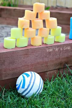 there are many blocks of soap on the ground next to a ball in the grass