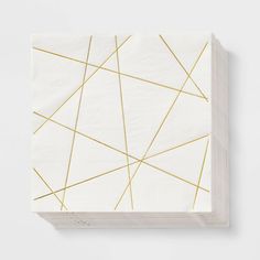 a white and gold paper with lines on the side, in front of a white background