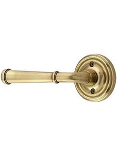 an antique brass door handle on a white background