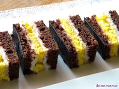 several pieces of cake on a plate with white and yellow frosting in the middle