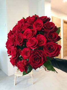 a large bouquet of red roses on a table