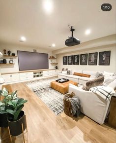 a living room filled with furniture and a flat screen tv mounted to the side of a wall