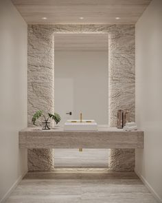 a bathroom with stone walls and flooring, including a sink under a mirror in the middle