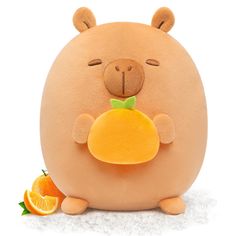 a stuffed animal with an orange in it's mouth