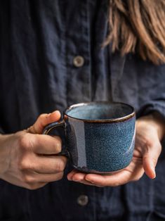 a person holding a cup in their hands