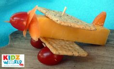 cheese, crackers and tomatoes on a wooden board