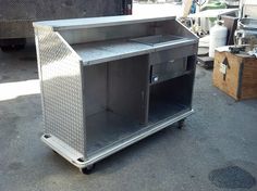 a silver metal cart sitting on top of a parking lot