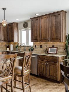 a kitchen with wooden cabinets and counter tops