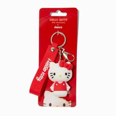 a hello kitty keychain with a red ribbon attached to it's side